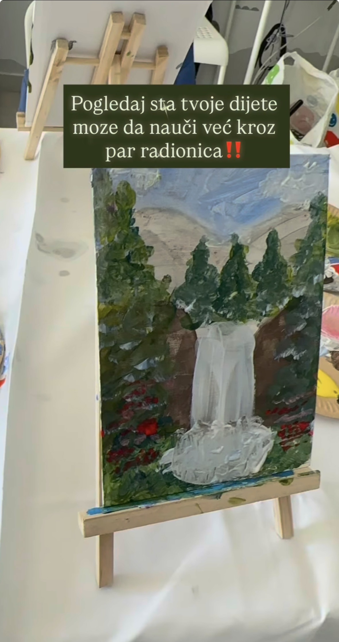 Children's painting of a waterfall on a small easel